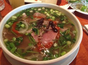 Beef pho from Pho 88 in Lowell. Swirls of sriracha and hoisin sauces wait to be mixed.     Photo by Denise Dubé.